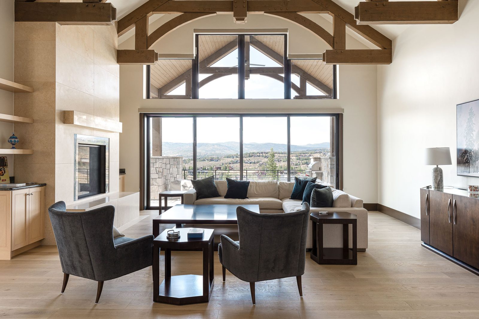 Custom home great room with vaulted timber ceilings and mountain views — Ensign Custom Homes Utah
