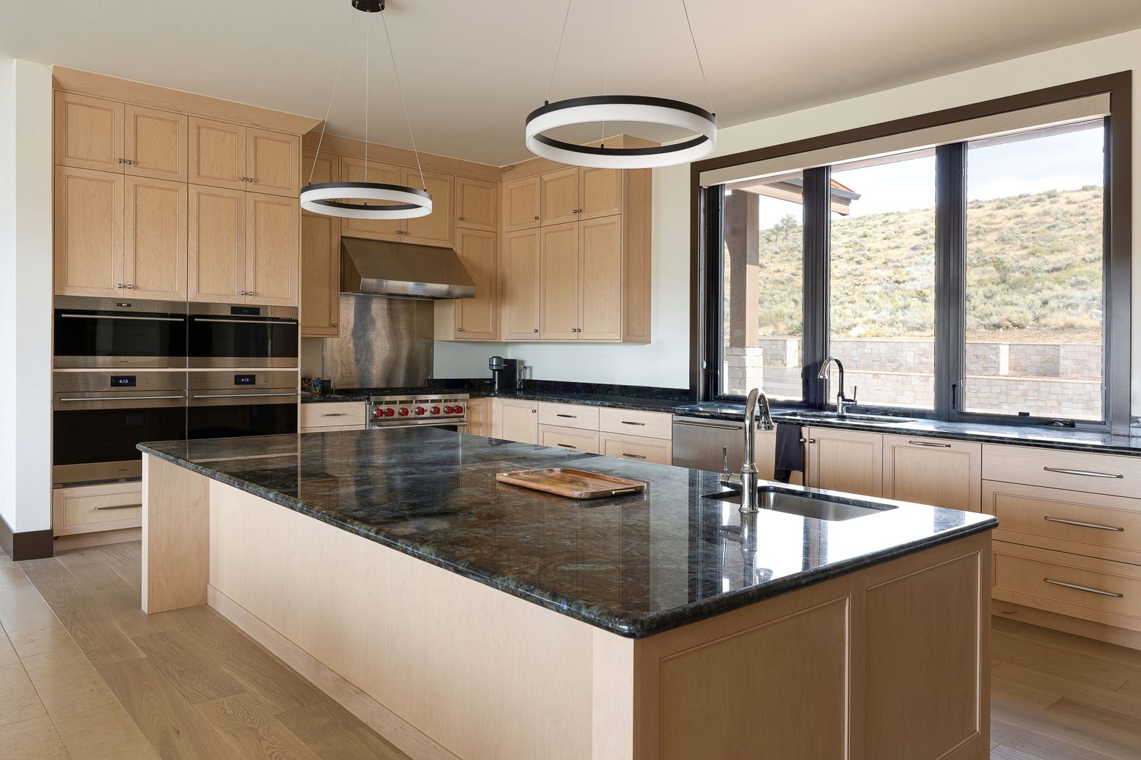 Chef's kitchen with granite island in luxury custom home — Ensign Custom Homes